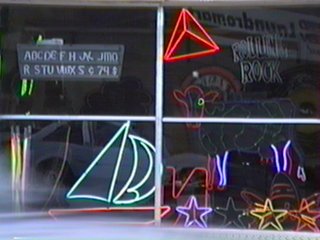 Storefront Window with Neon and Reflections